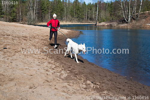 Image of Running the sports woman with a dog