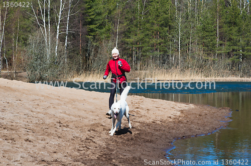 Image of Running the sports woman with a dog