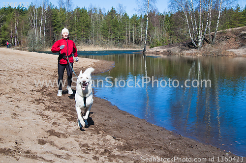 Image of Running the sports woman with a dog