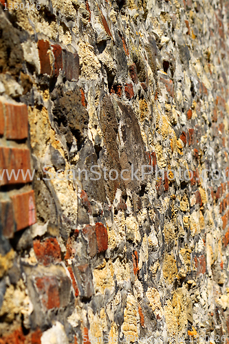 Image of old stone and brick wall in perspective