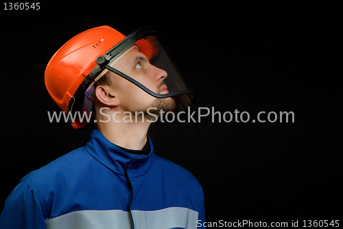 Image of worker in overalls and a helmet