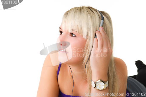 Image of Young beautiful girl listening to music