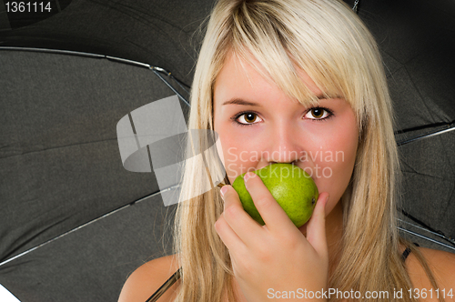 Image of Young girl eating a pear