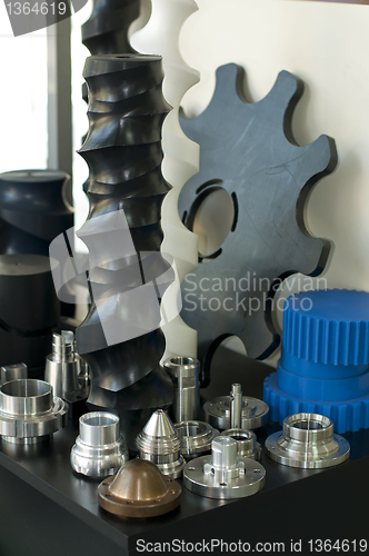 Image of Plastic and metal machine parts. Vertical imagel