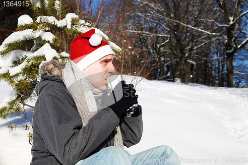 Image of Man sitting in the snow