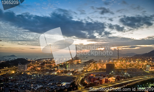 Image of Port warehouse with cargoes and containers at night 