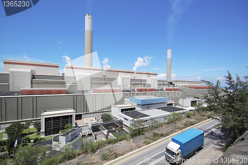 Image of coal fired power station and car moving