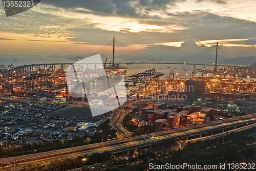 Image of Port warehouse with cargoes and containers at night 