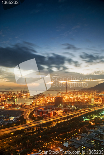 Image of Port warehouse with cargoes and containers at night 