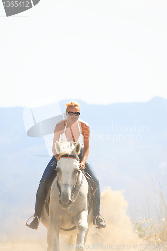 Image of Young rider on the beach