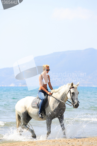 Image of Young rider on the beach