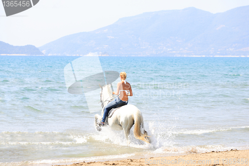 Image of Young rider on the beach