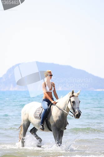 Image of Young rider on the beach