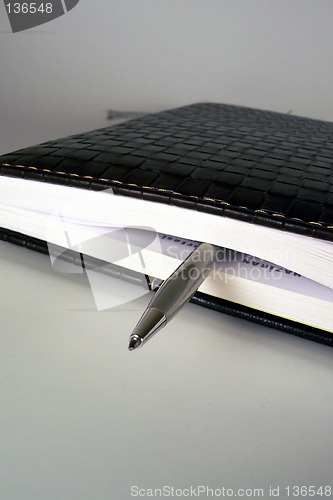 Image of pen in a notebook