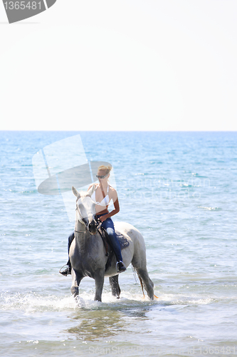 Image of Young rider on the beach