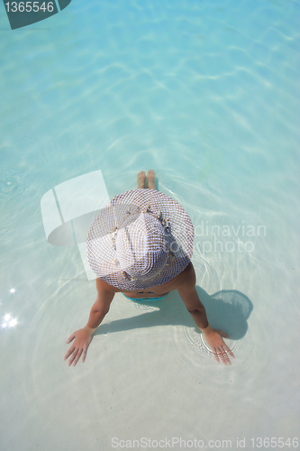 Image of Beautiful young woman at a pool