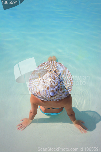 Image of Young woman in a swimming pool