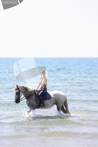 Image of Young rider on the beach