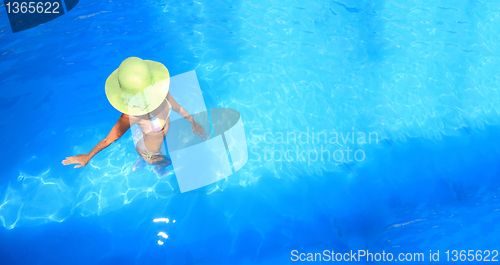 Image of woman enjoying a swimming pool