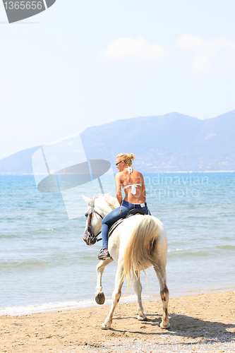 Image of Young rider on the beach