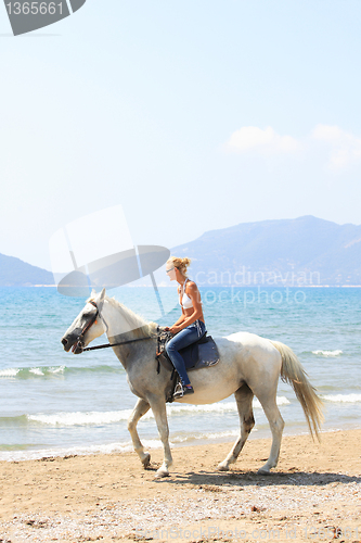 Image of Young rider on the beach