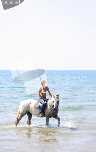 Image of Young rider on the beach