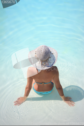 Image of Beautiful young woman at a pool