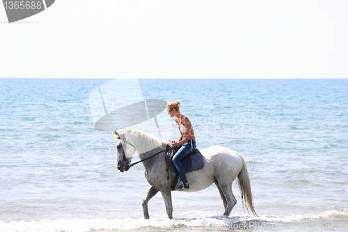 Image of Young rider on the beach