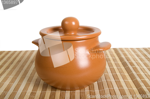 Image of Clay pot on the striped mat