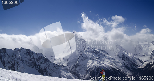 Image of Panorama Mountains. Ski slope with skier. 