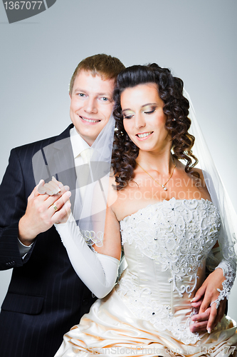 Image of just married groom and  bride on gray
