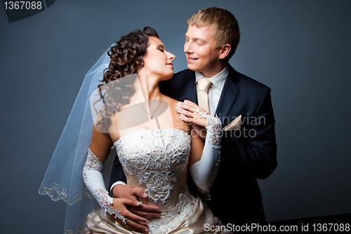 Image of bride and groom embracing and looking at each other