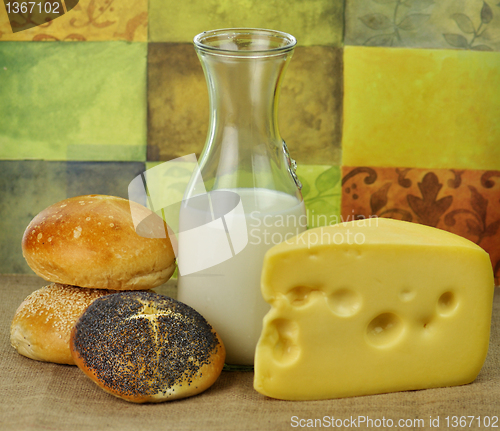 Image of milk bottle , cheese and fresh rolls