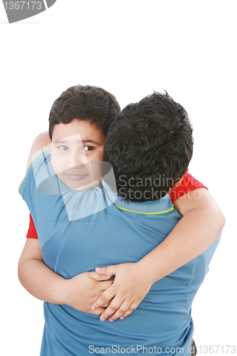 Image of Portrait of a young boy hugging his father against white backgro