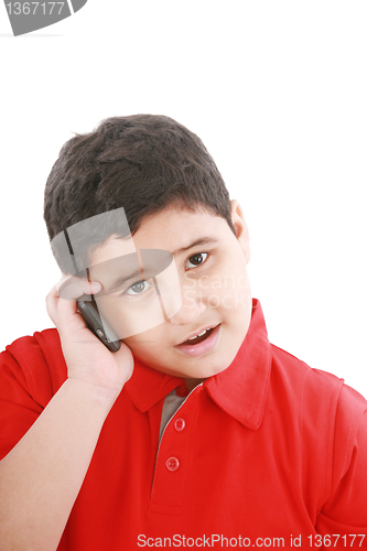 Image of Young boy talking to cell phone, isolated on white background. 