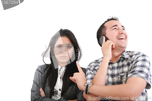 Image of Impatient woman standing with arms crossed looking at his boyfri