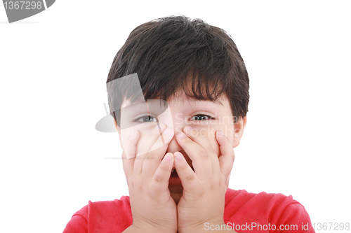 Image of Preschool aged boy with his hand/fists over his mouth; looking e