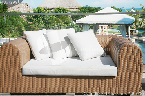 Image of Outside lounge area nice framed with plants, flowers, pool and b