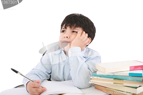 Image of Upset schoolboy doing homework isolated on white 