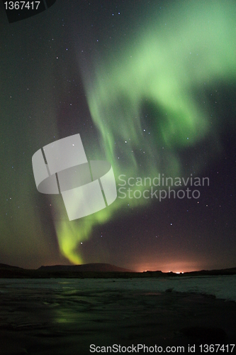 Image of Aurora borealis over the frozen river in Iceland