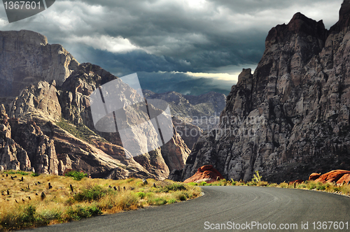 Image of road to mountains and dramatic sky 