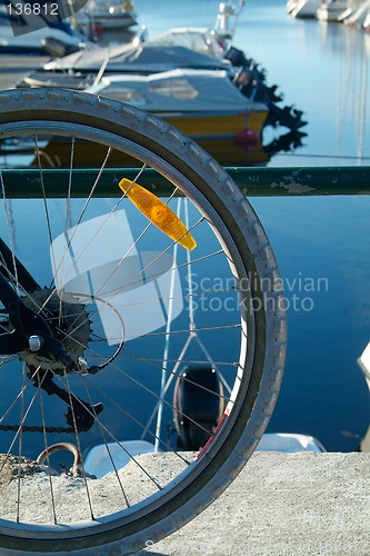 Image of Bicycle wheel and boats