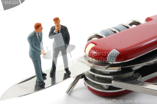 Image of business people on penknife