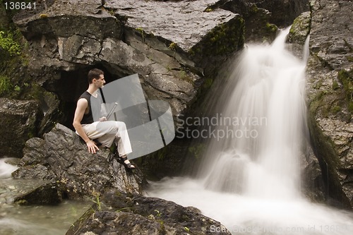 Image of martial arts - meditation next to waterfall