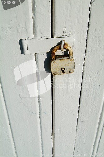 Image of Detail of old, wooden door with padlock