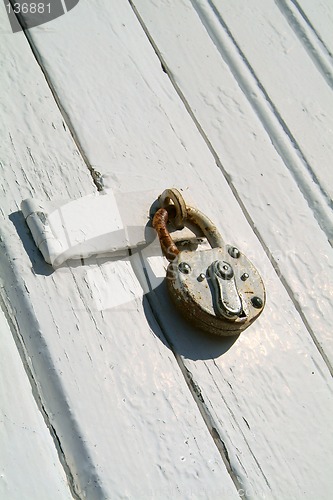 Image of Detail of old, wooden door with padlock