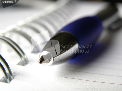 Image of Blue pencil on spiral note book