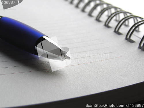 Image of Blue pencil on spiral note book