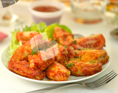 Image of hot chicken wings with salad