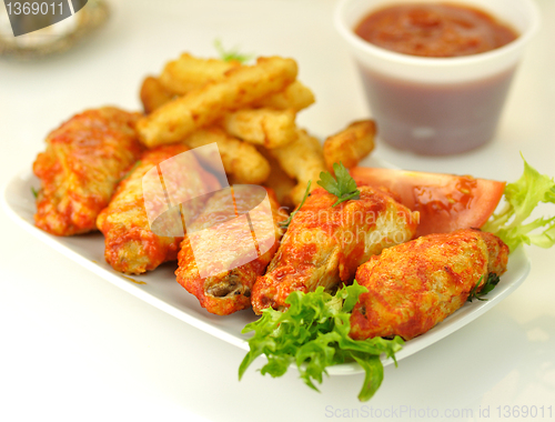 Image of hot chicken wings with fried potatoes 